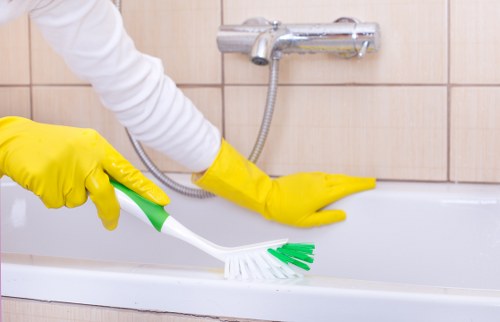 Technician operating carpet cleaning equipment with attention to safety procedures
